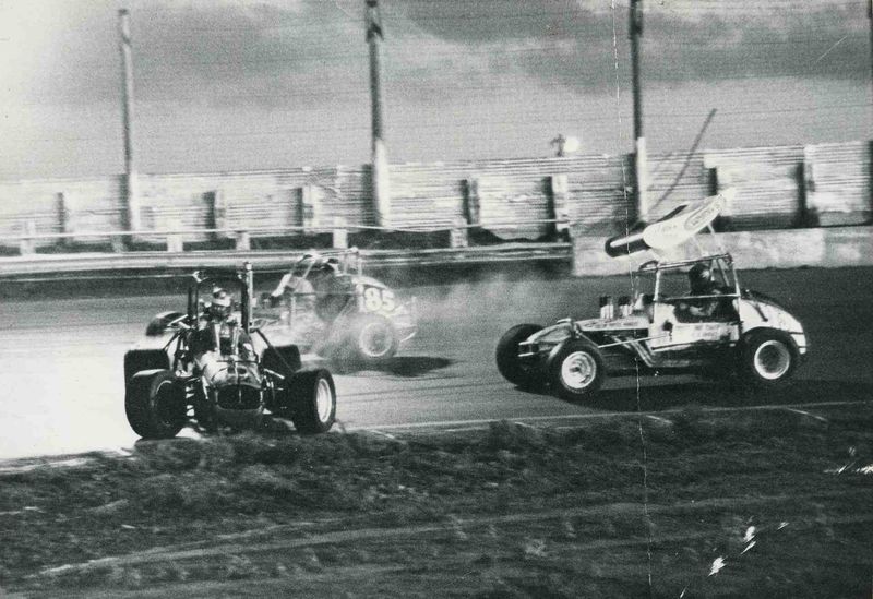 Unknown sprinter loops it in front of Wolfman as Gary Holloway shoots by on the outside, Lubbock, 1973.